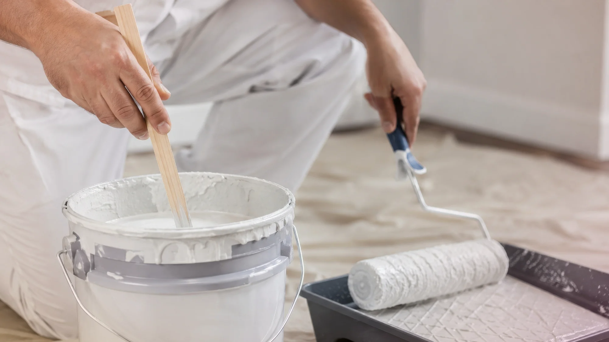 Professional painters in Annapolis MD carefully preparing a room for painting.